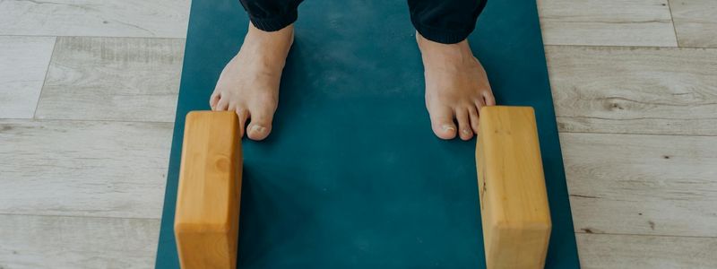 Yoga blocks and a rolled mat on the floor.